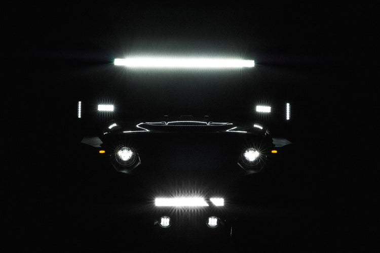 Silhouette of jeep with off road lights on. Dark background.