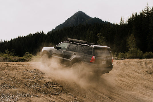 4Runner driving up inline with dust cloud. Forest in the distance. Photo by Blake Carpenter.