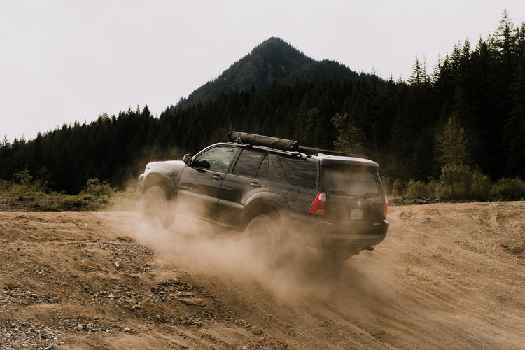 4Runner driving up inline with dust cloud. Forest in the distance. Photo by Blake Carpenter.